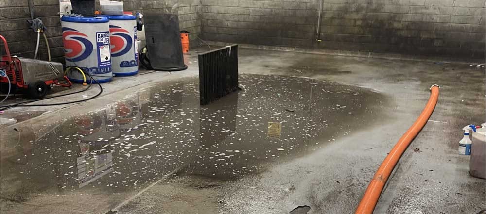 Emergency commercial drain clearance removing standing water from a Bracknell business floor